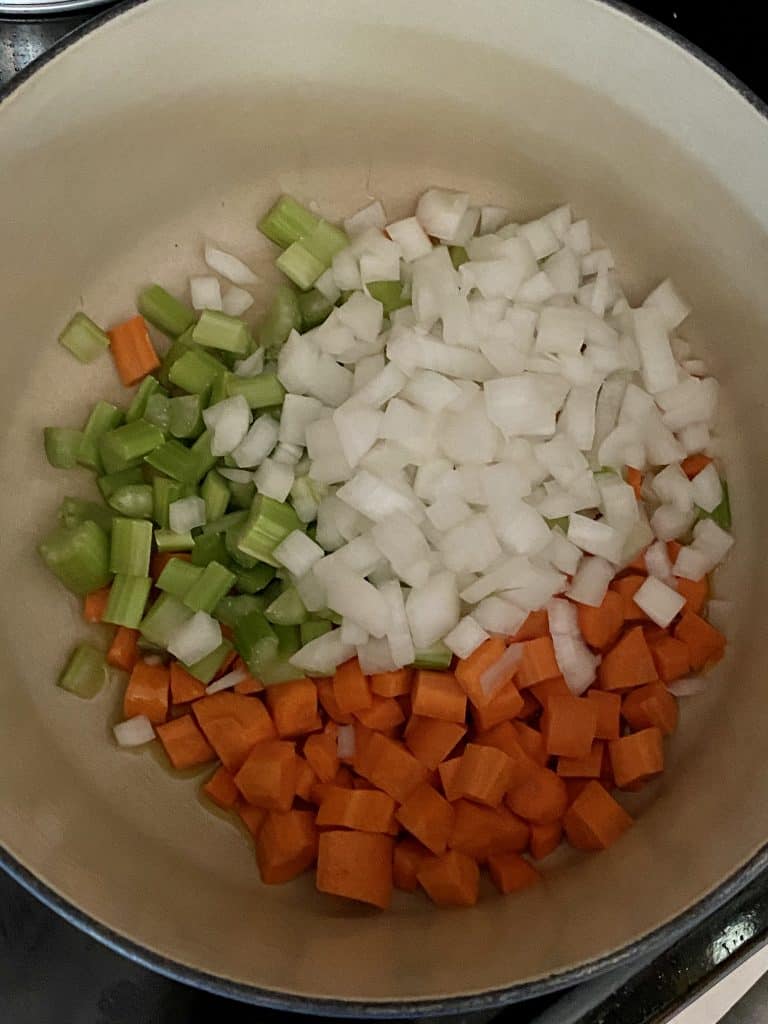 carrots, celery, and onion in a pot for cheeseburger soup