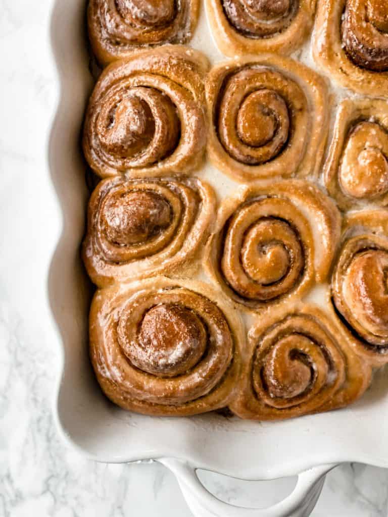 cooked sweet rolls in a white ceramic pan