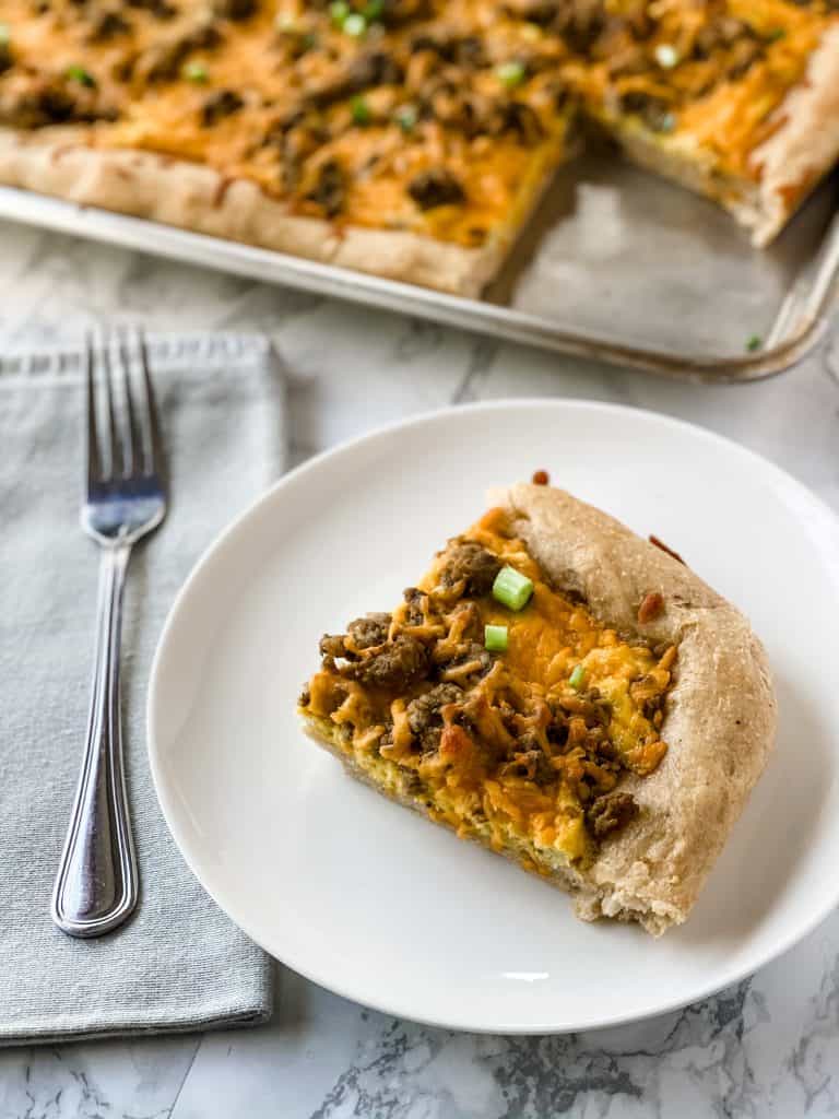 a slice of breakfast pizza on a plate