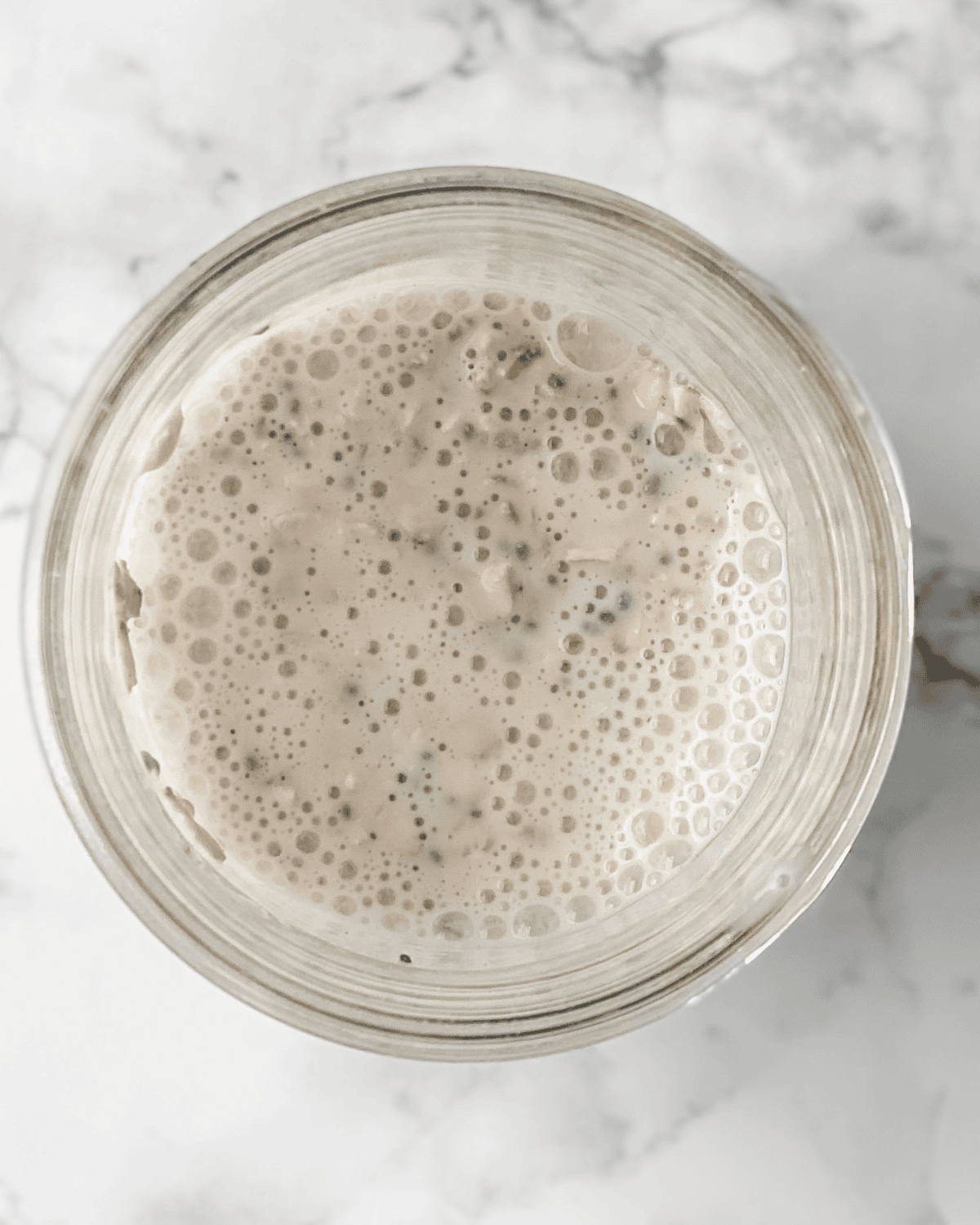 all of the overnight oats ingredients mixed together in the mason jar.