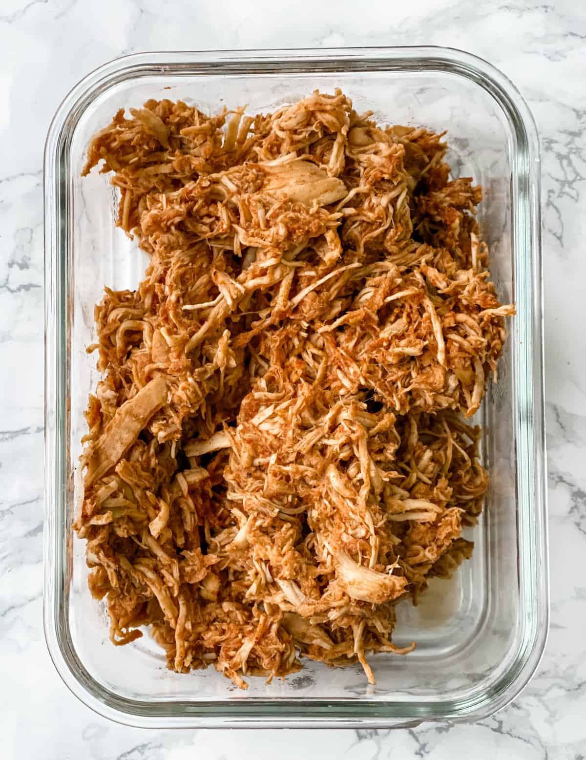 shredded taco chicken in a meal prep container