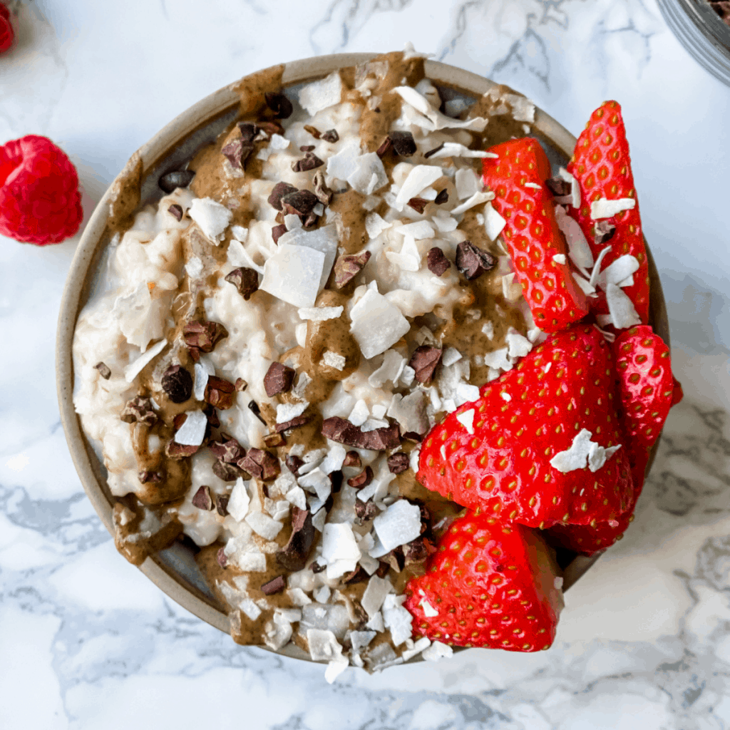 bowl of oatmeal with almond butter and strawberries on top