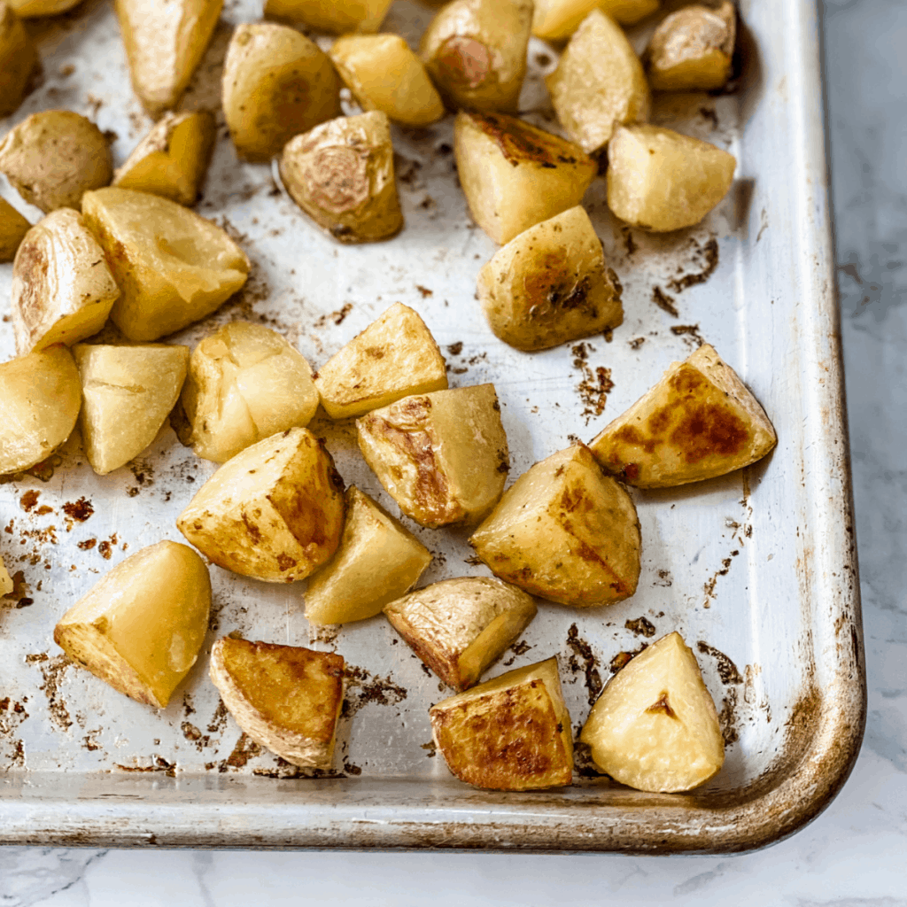 golden brown potatoes on baking sheet