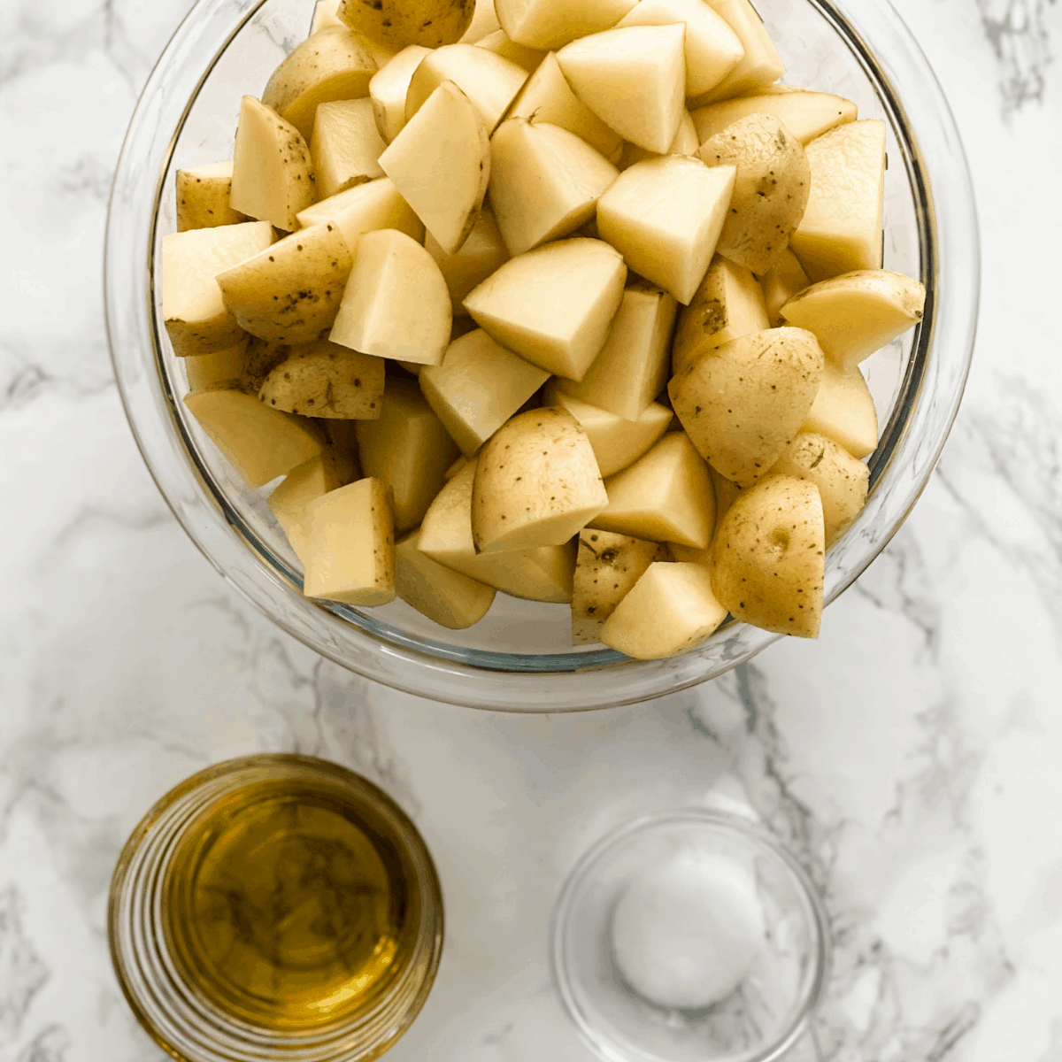 ingredients for crispy oven roasted potatoes. Potatoes, olive oil, and salt.