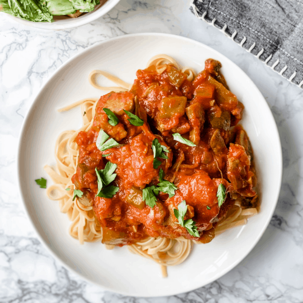 Chicken Cacciatore served with linguini.