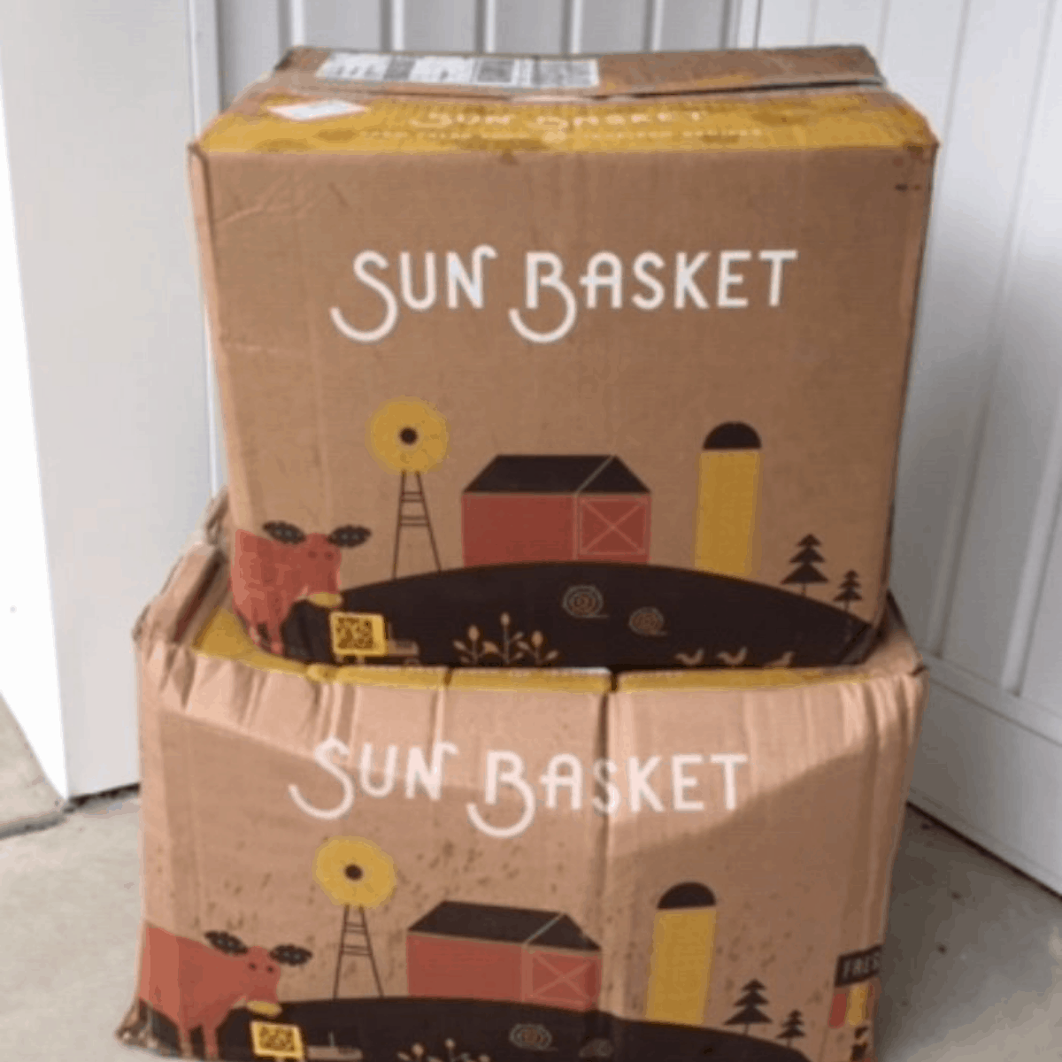 2 boxes from Sun Basket on the front porch