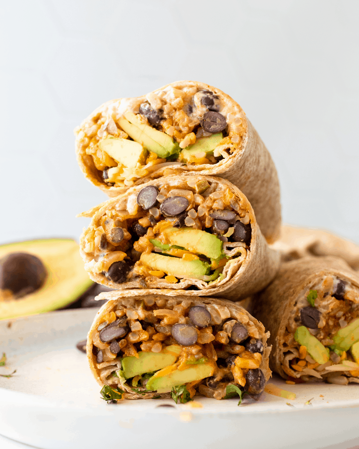 black beans and rice burritos stacked on top of one another.