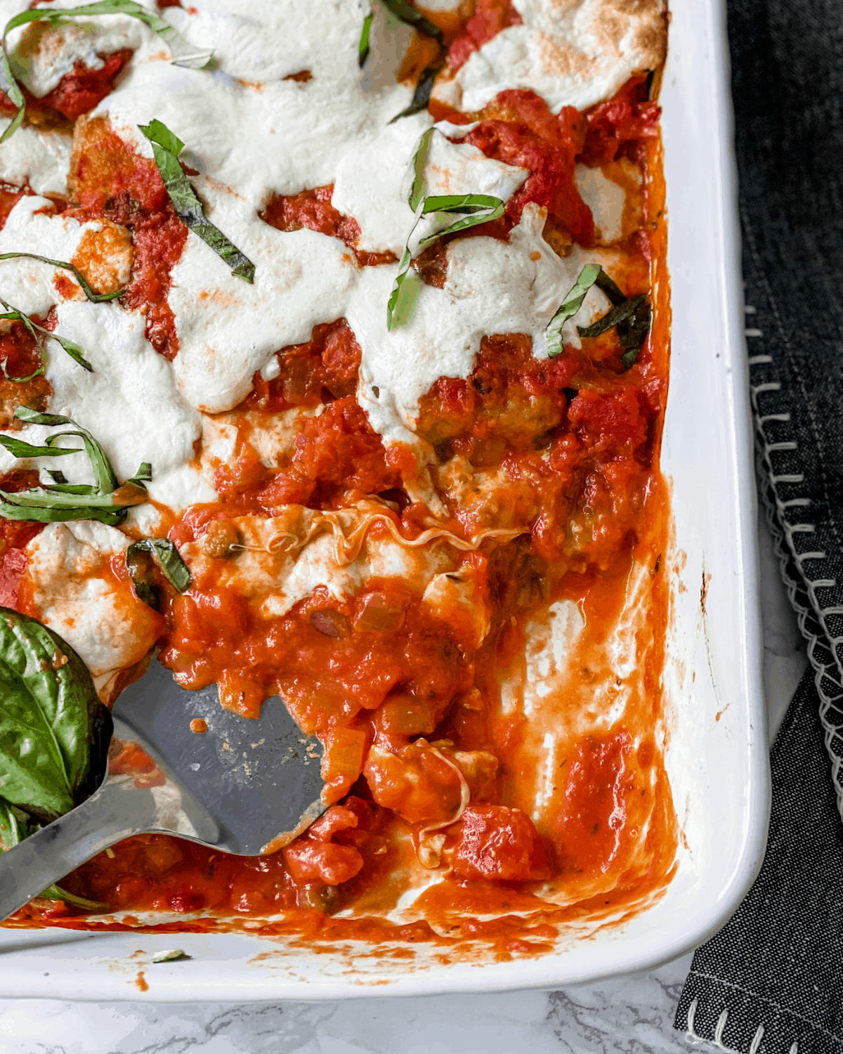 Eggplant Parmesan with a piece taken from the corner.