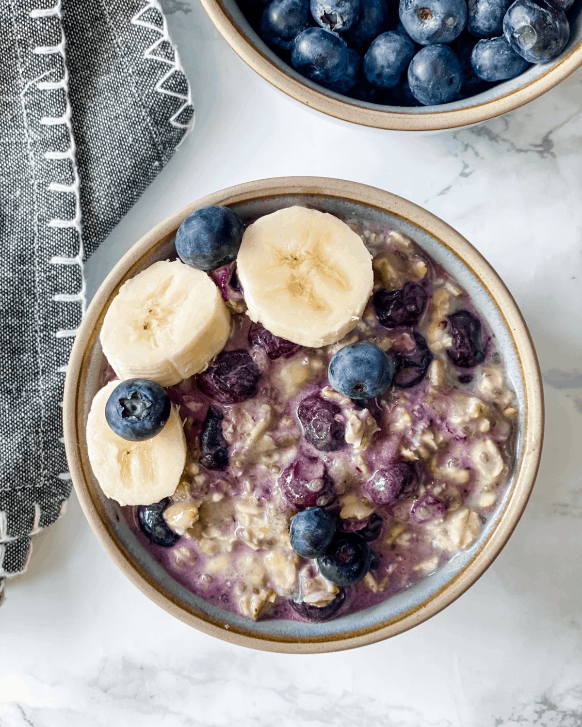 Delicious Creamy Oatmeal with Blueberries and Bananas in a Bowl