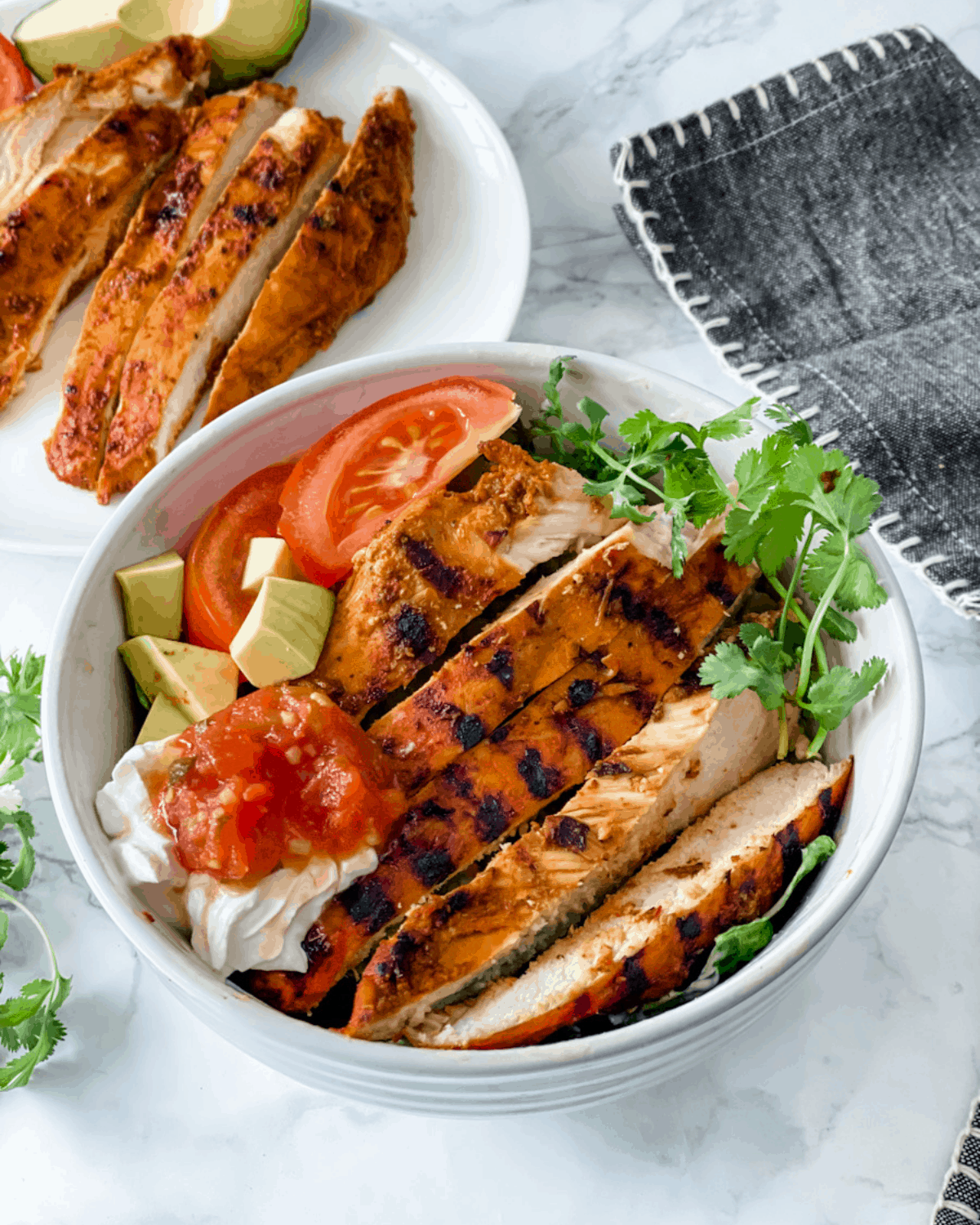 chipotle chicken cooked and sliced on a salad.