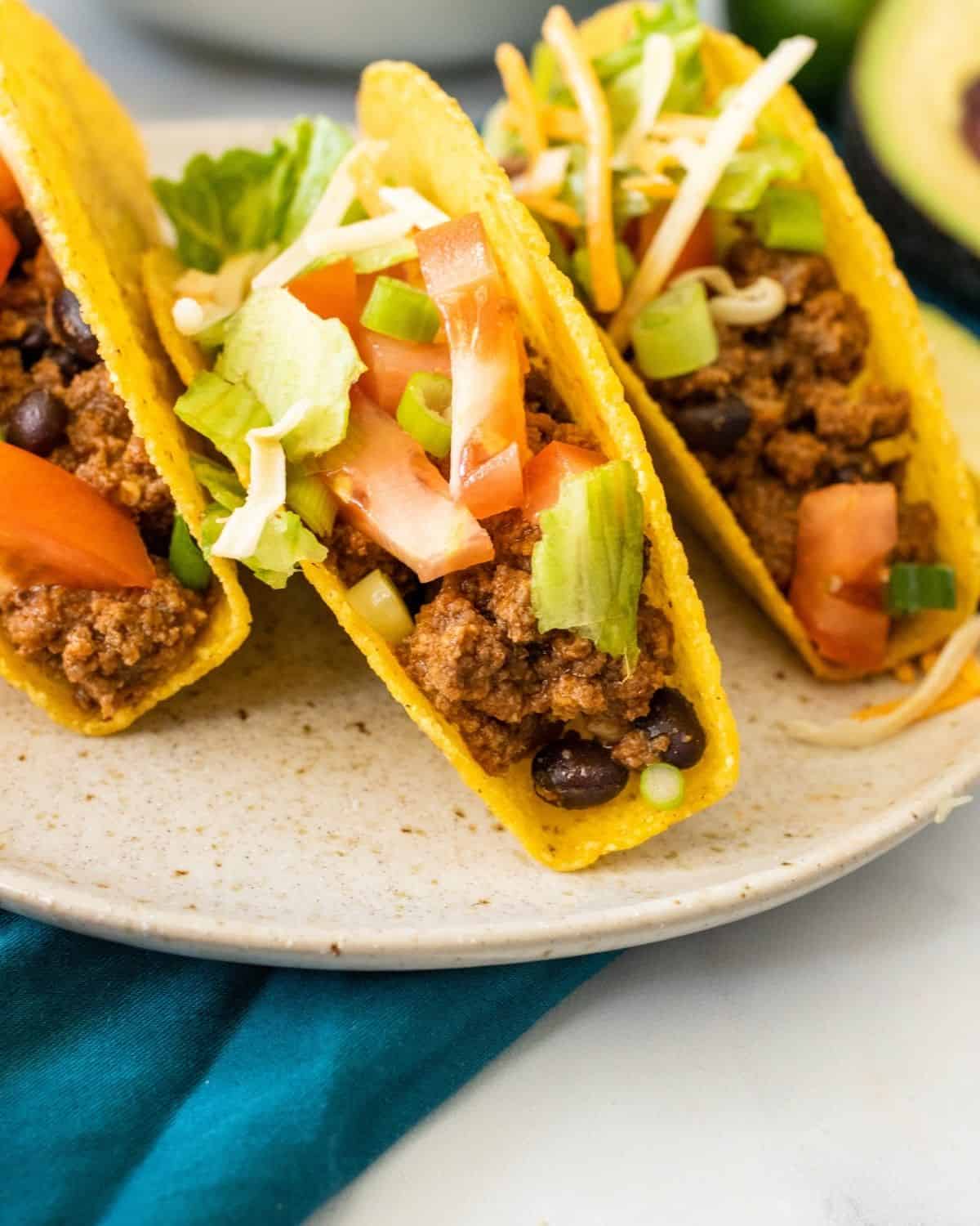 a close up of the ground beef tacos and black in a hard shell