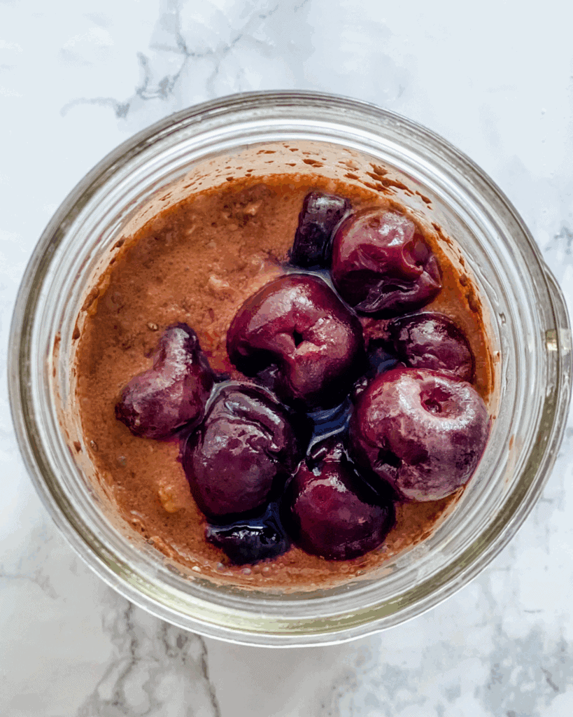 overhead picture of overnight oats with the cherries on top.