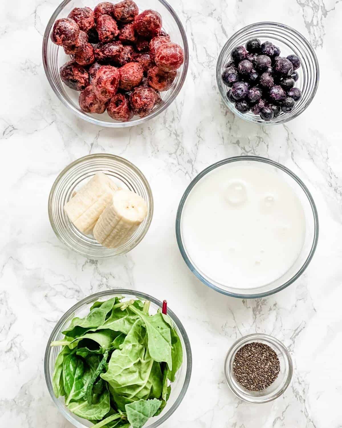 ingredients to make a vegan blueberry cherry smoothie