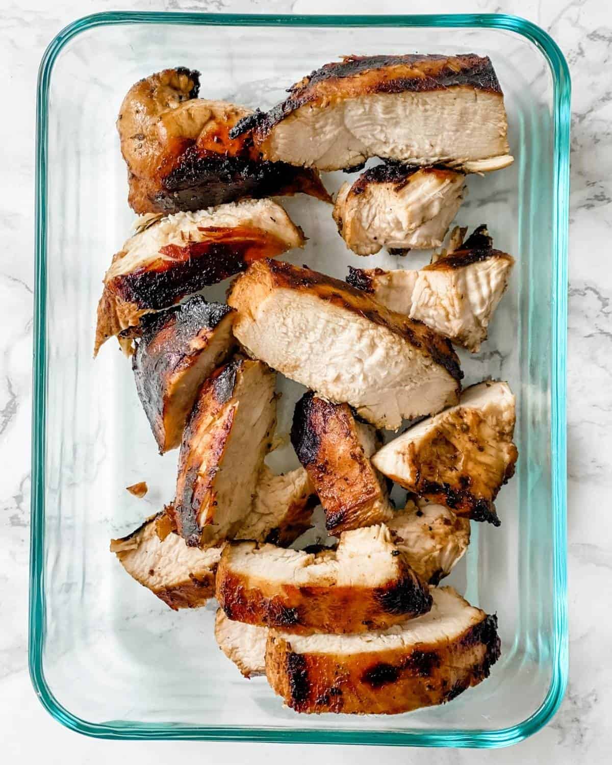 sliced grilled chicken in a meal prep container for the week