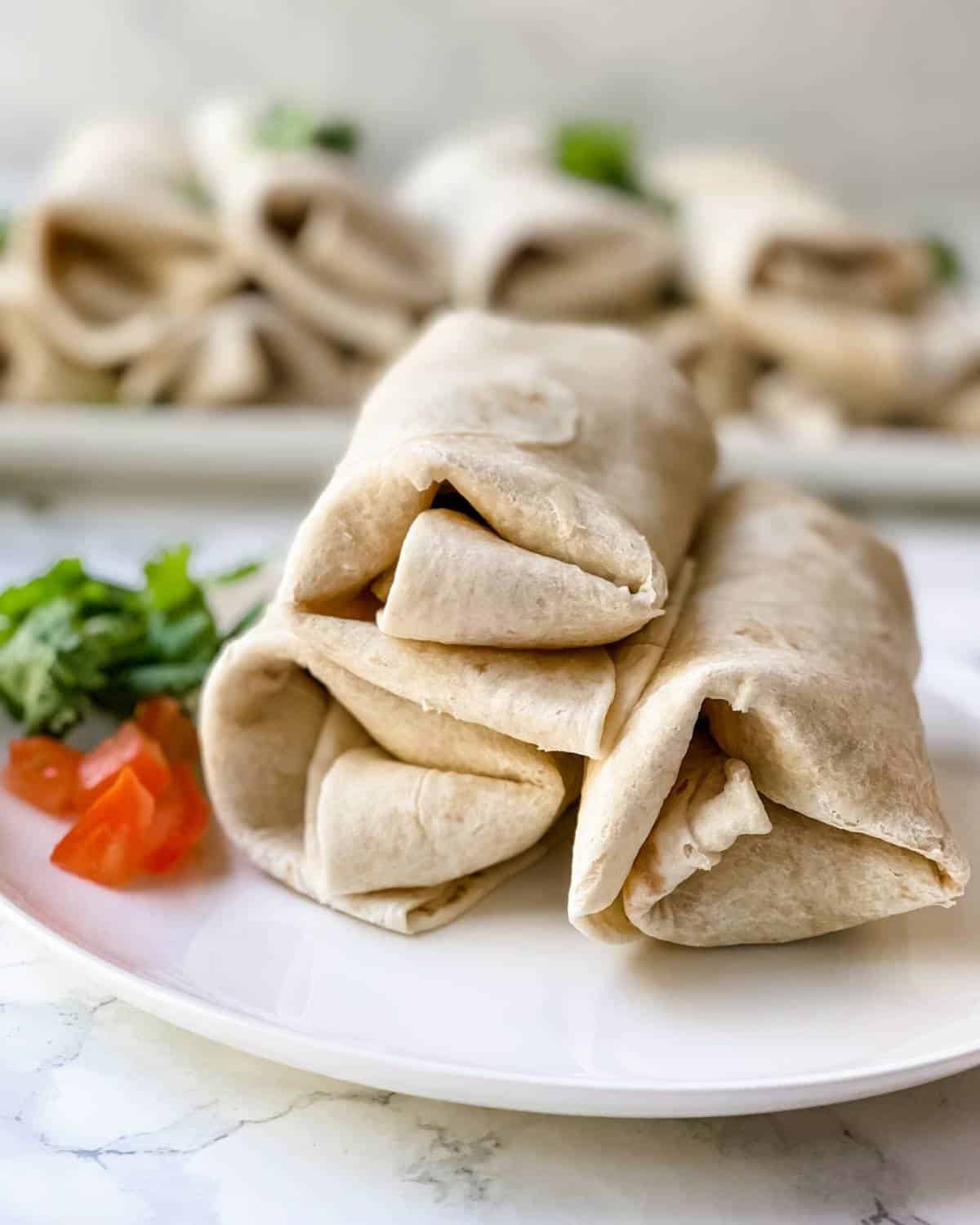 breakfast burritos that are prepared and on a plate