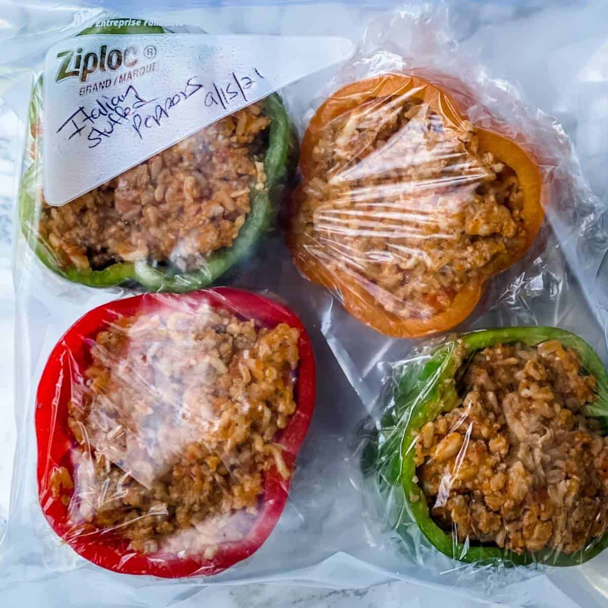 bell peppers with filling wrapped in plastic and in a freezer bag.