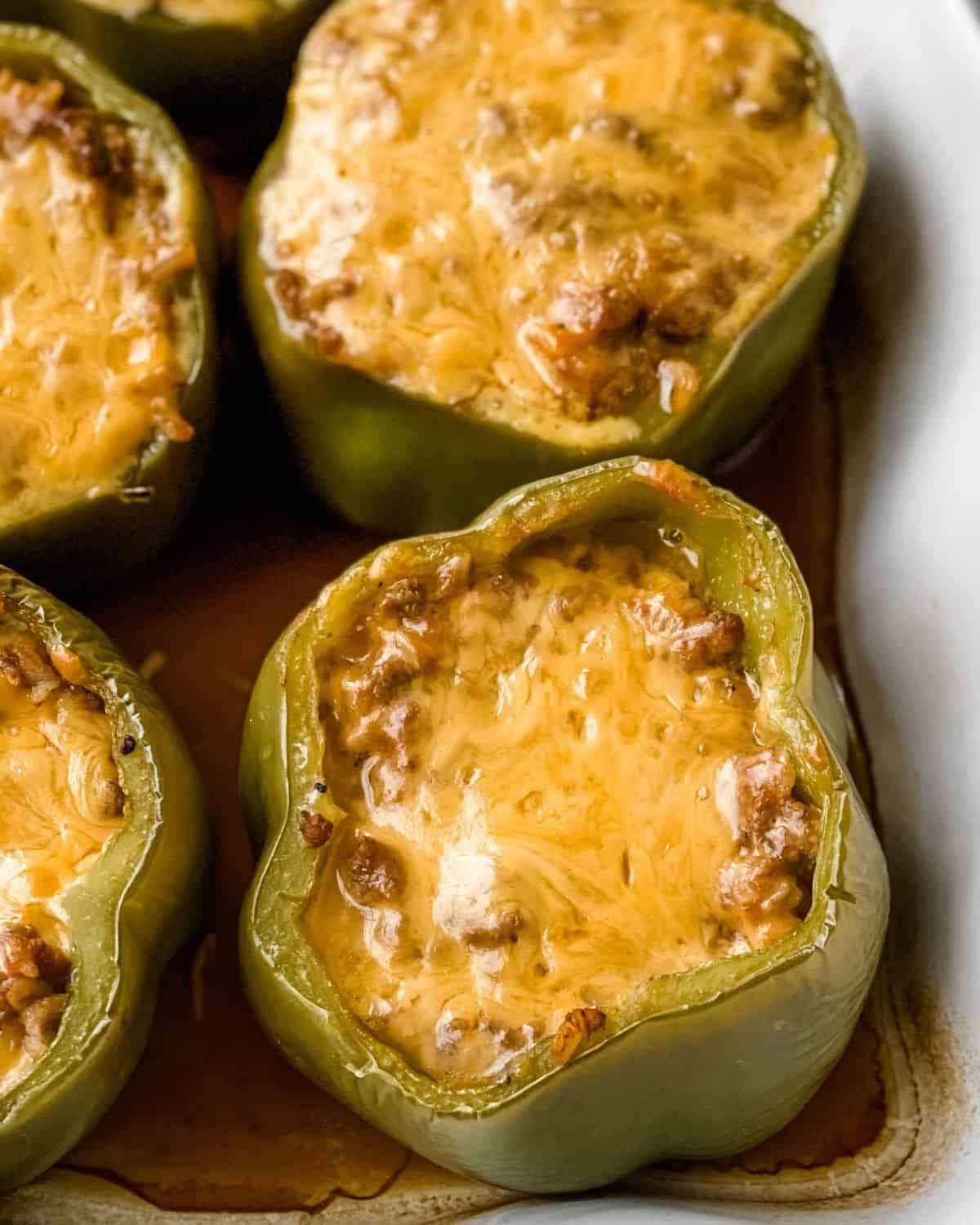 Cheeseburger stuffed with peppers in a baking dish.