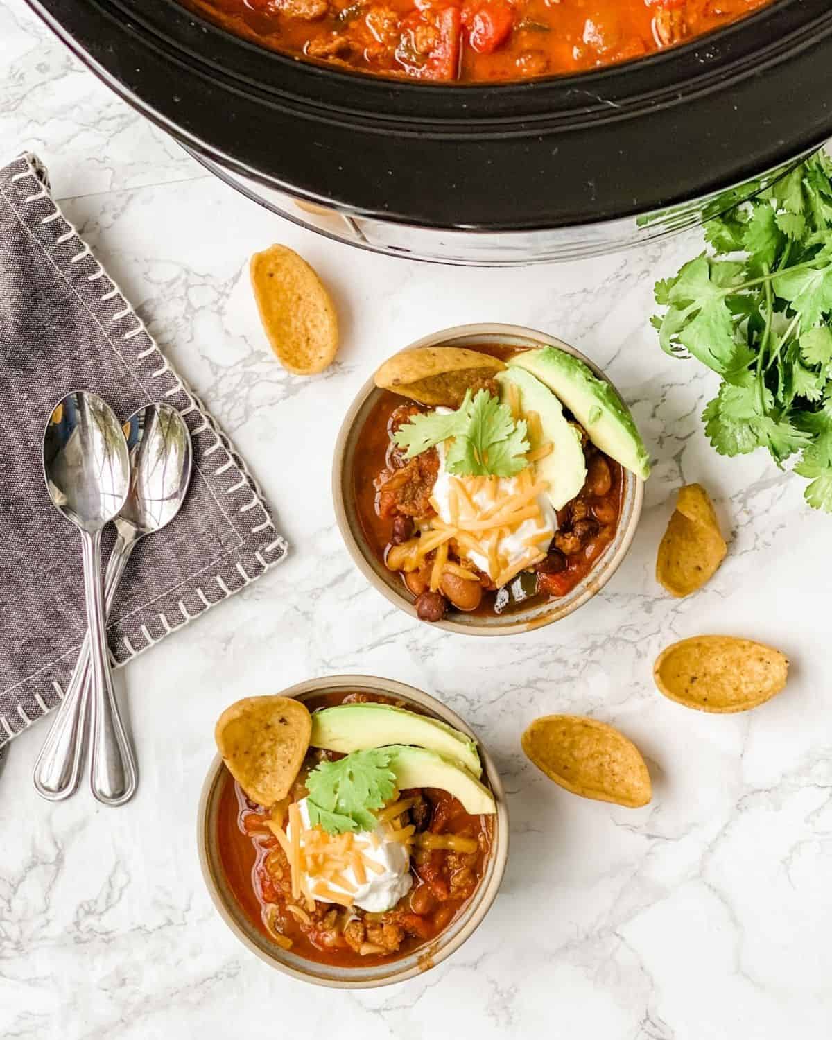 overhead picture of sausage chili in bowls
