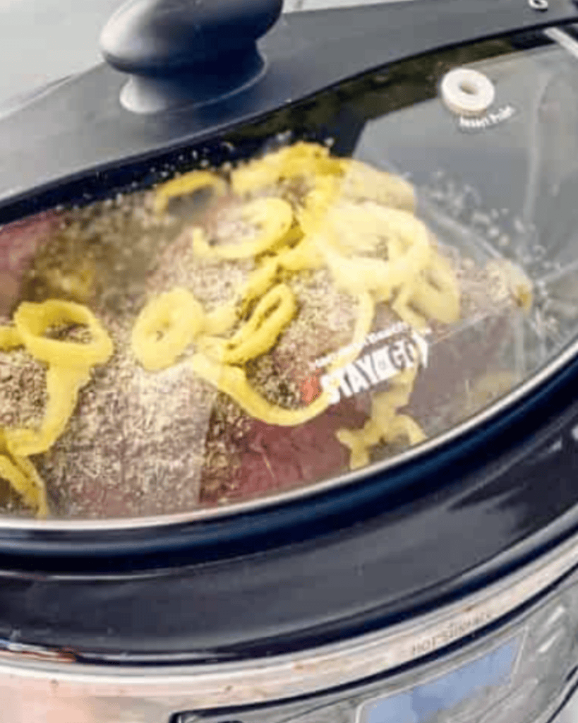 italian beef in slow cooker covered.