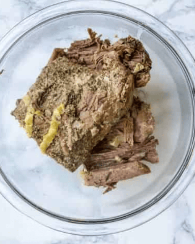 cooked italian beef in the bowl.