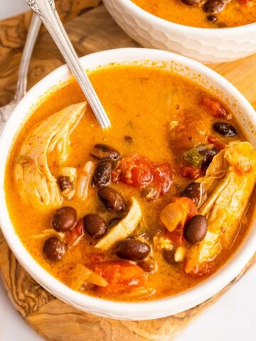 chicken enchilada soup in a bowl with a spoon