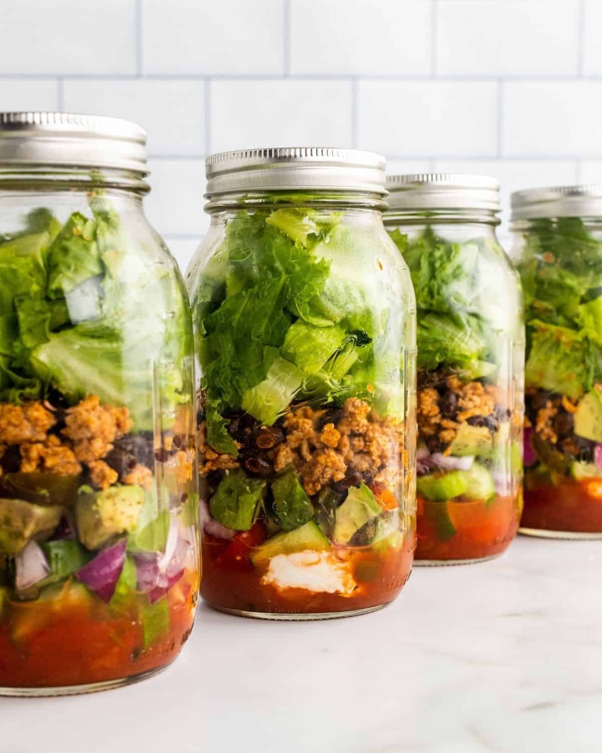 taco mason jar salads in a row