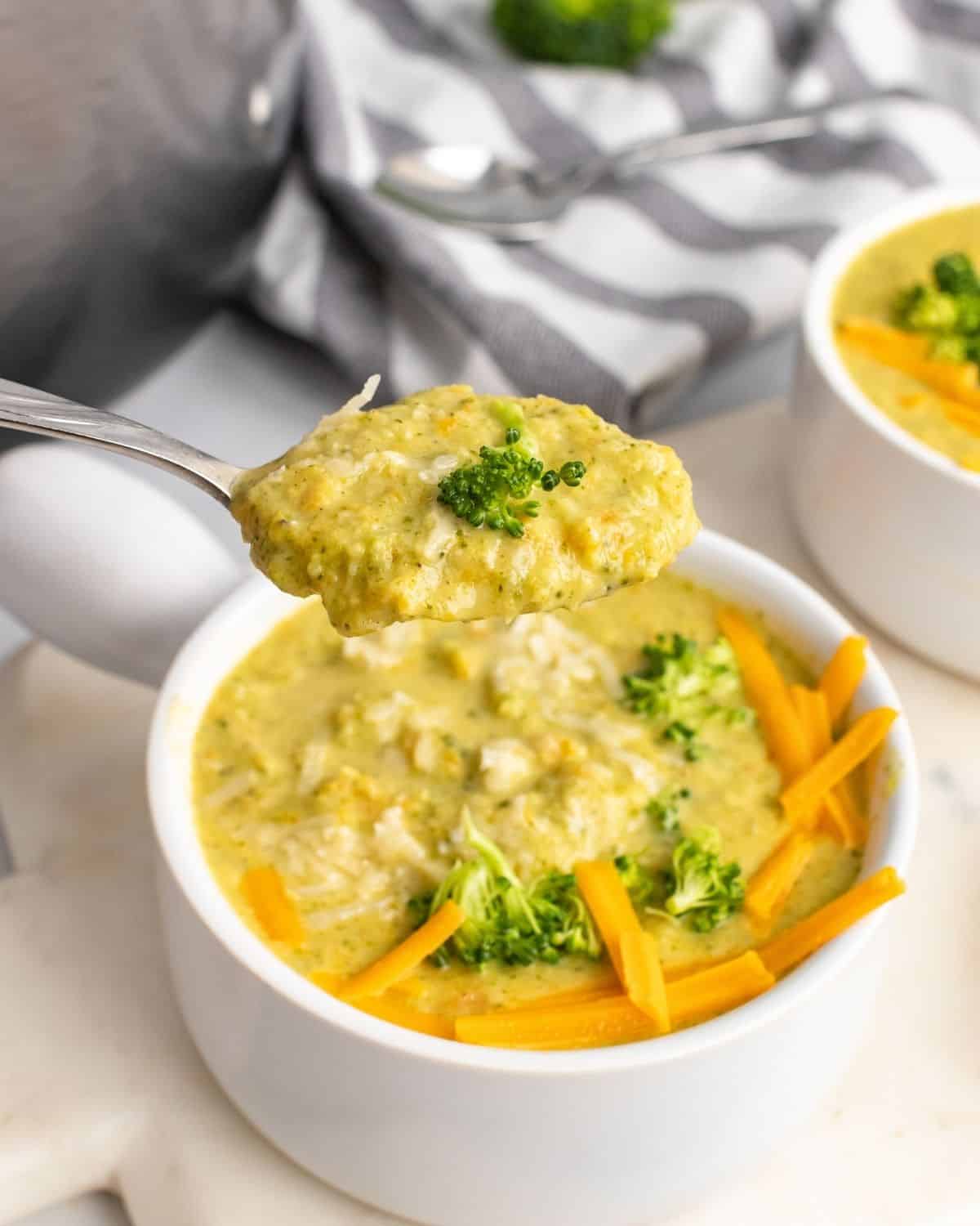 a close up spoonful picture of the broccoli cheddar soup.