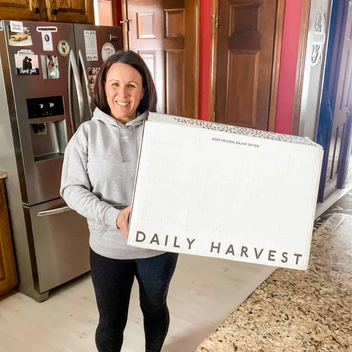Tammy Overhoff holding a box of Daily Harvest to review
