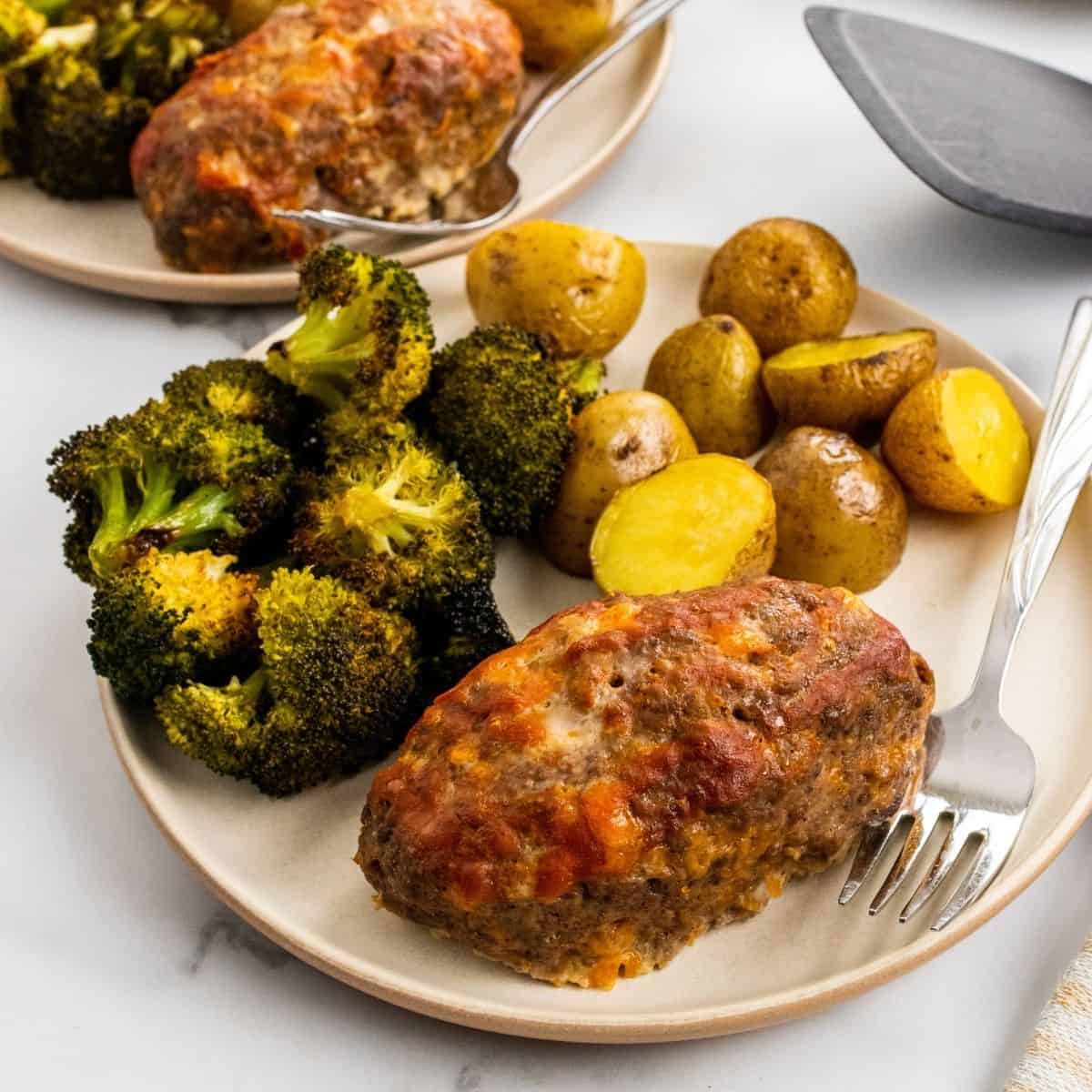 mini meatloaf recipe. One meatloaf portion on a plate with broccoli and potatoes