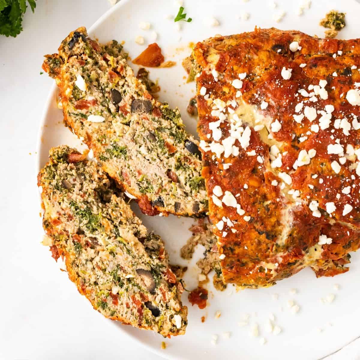 Greek turkey meatloaf sliced and put onto a plate.