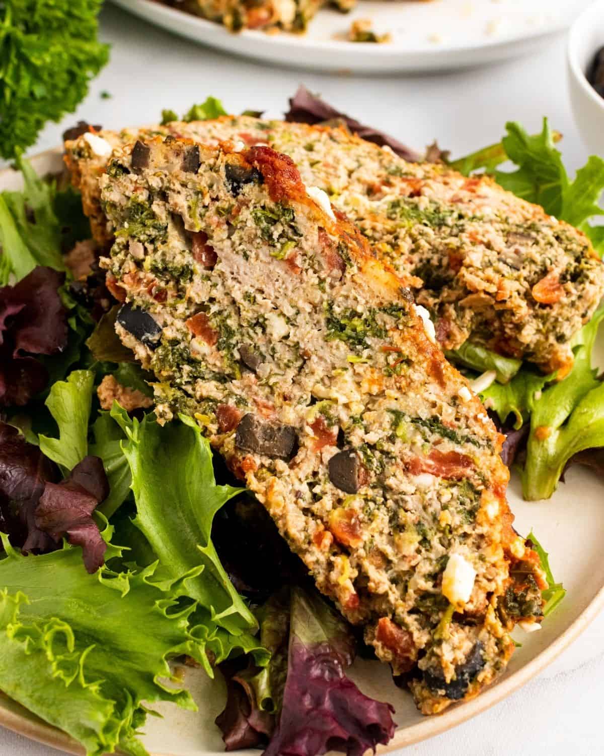 Close-up picture of two slices of greek meatloaf on a plate