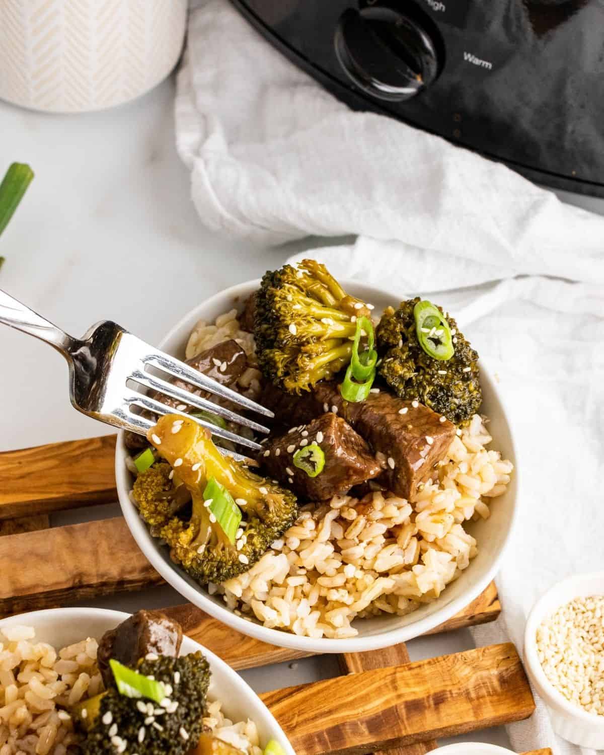 overhead picture of slow cooker beef and broccoli with a fork