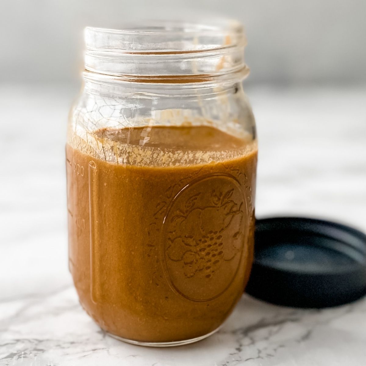 Thai peanut dressing in a mason jar.