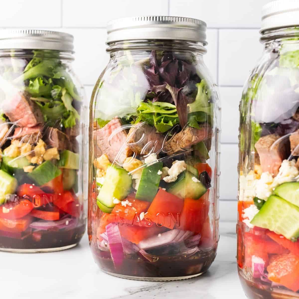steak salad recipe layered into a mason jar