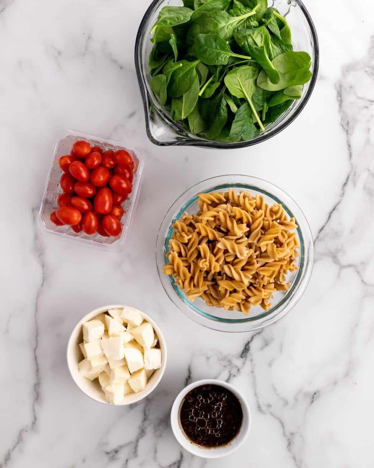 ingredients to make spinach pasta salad in a jar.