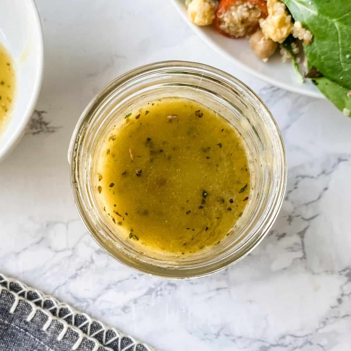 overhead picture of homemade Italian dressing in a mason jar.