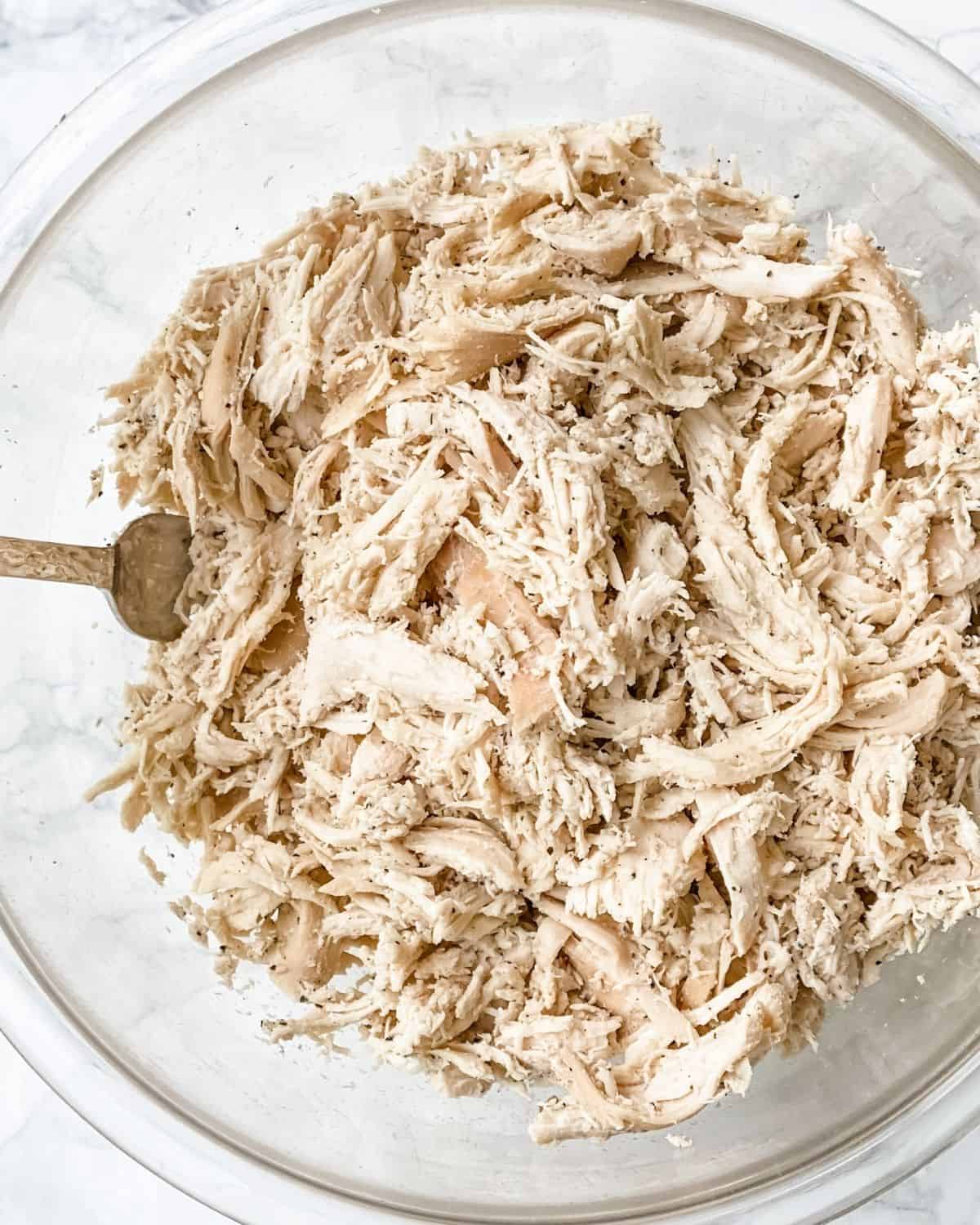 shredded chicken breasts in a bowl.