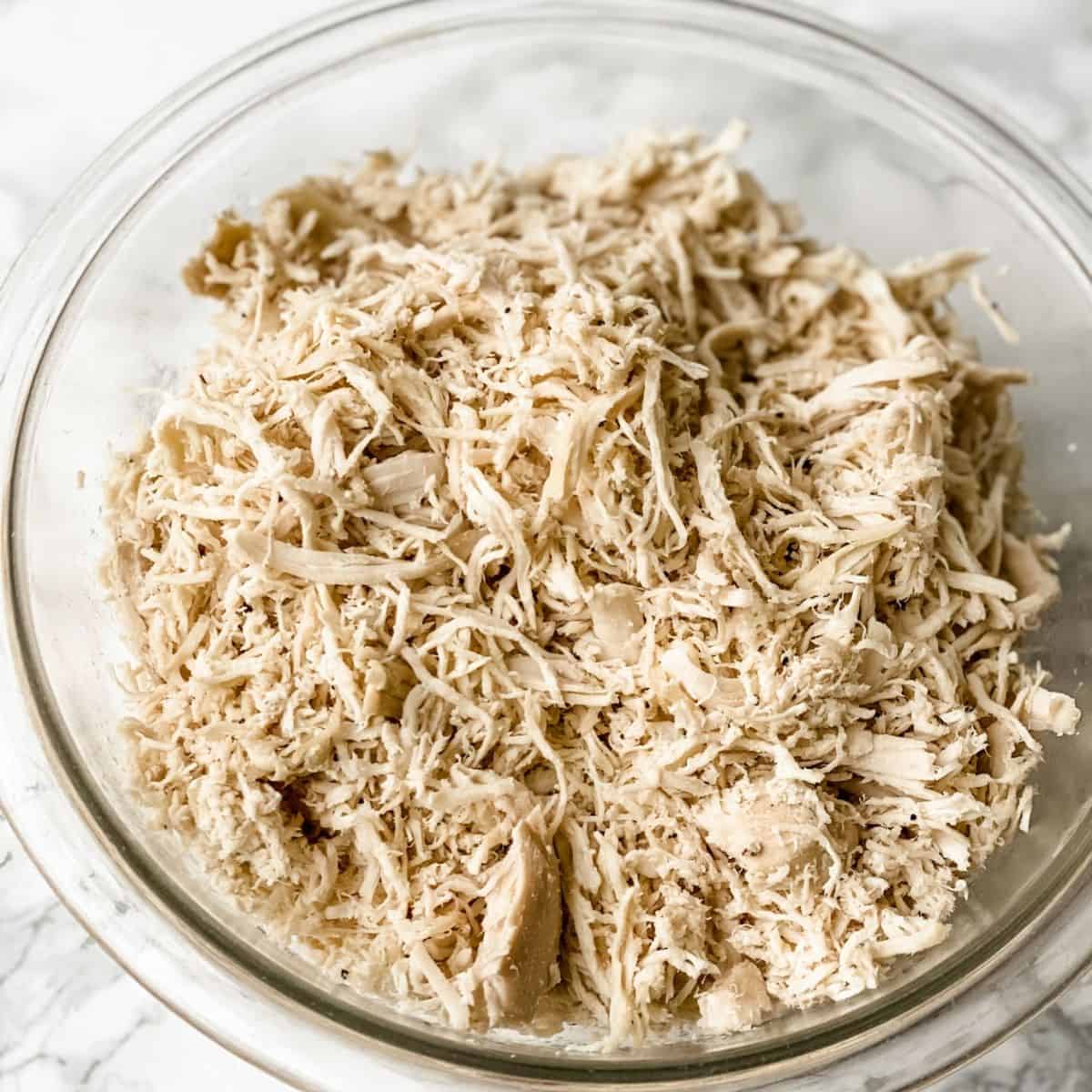 crock pot shredded chicken in a bowl.