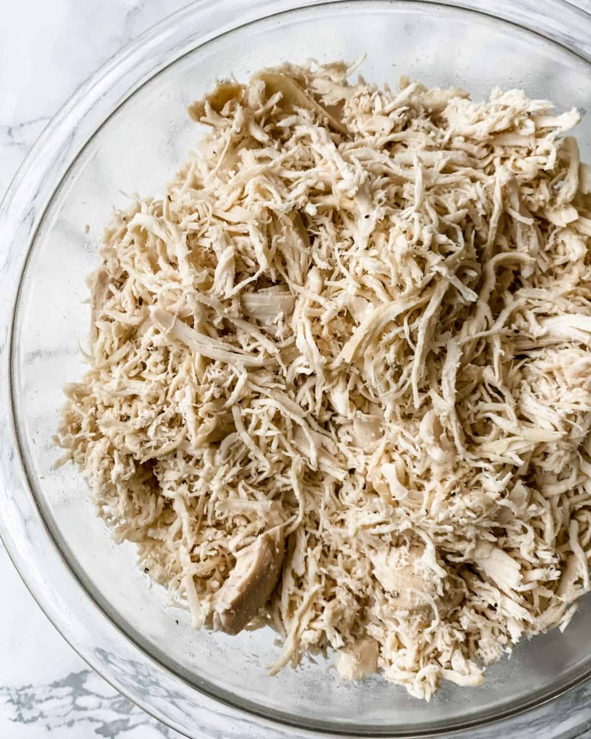 overhead picture of shredded chicken in a bowl.