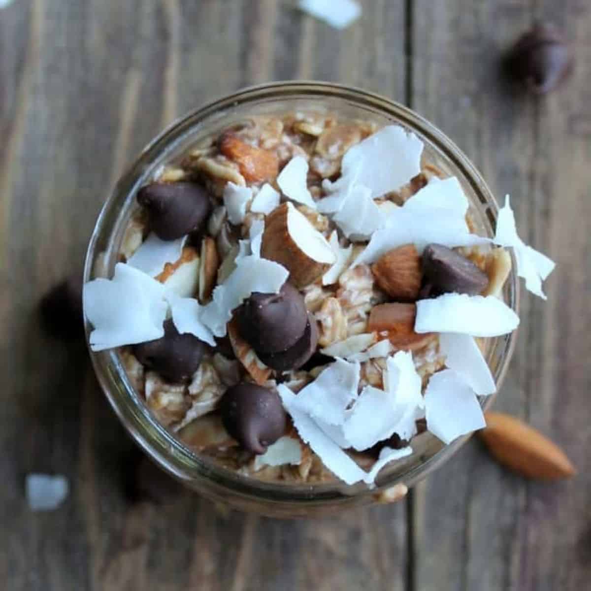 Overhead photo of Almond Joy Overnight Oats topped with chopped almonds, coconut and chocolate chips.