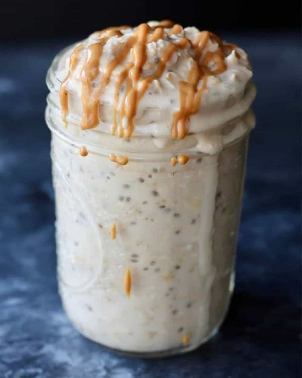 a jar of peanut butter overnight oats with drizzle of peanut butter