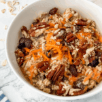 close-up view of carrot cake overnight oats in a white bowl