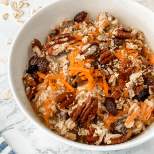 close-up view of carrot cake overnight oats in a white bowl