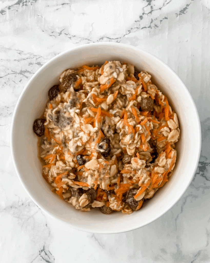 Carrot cake overnight oats in a white bowl.