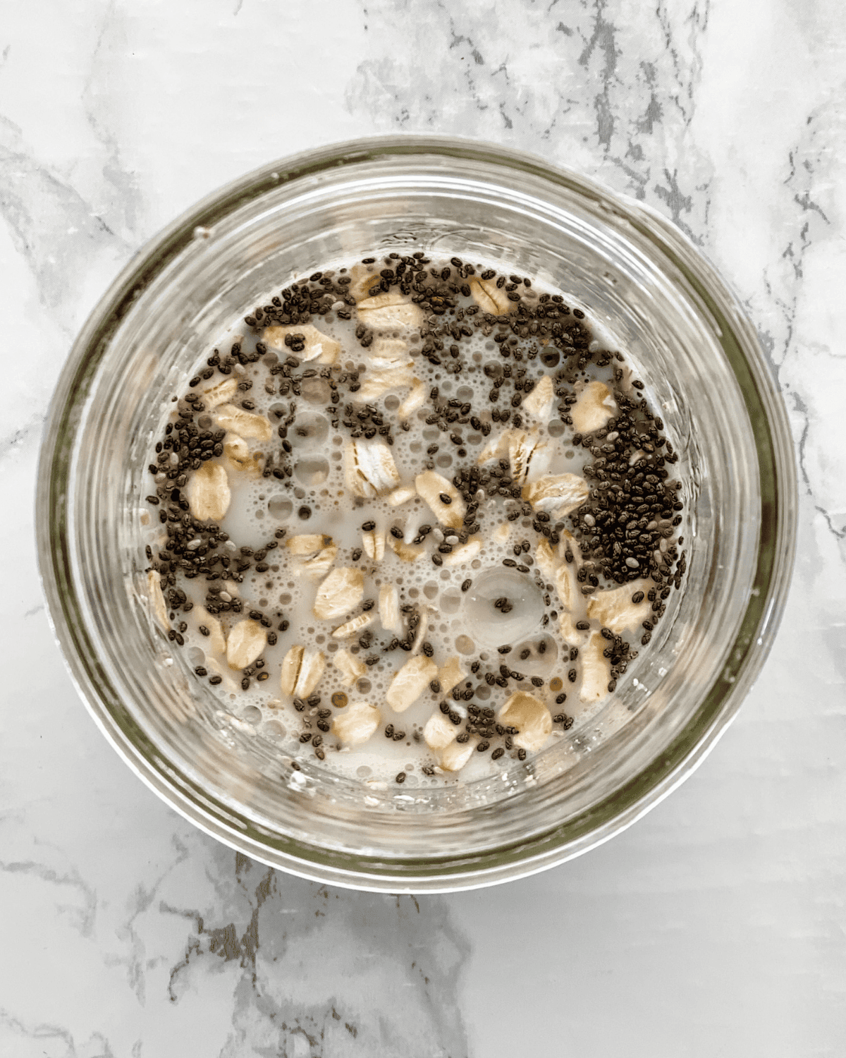 oats, chia seeds, and milk in a jar