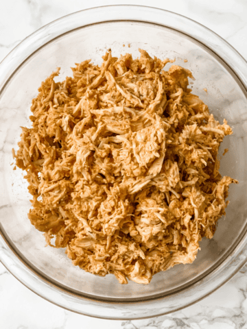 overhead of buffalo chicken in a glass bowl.