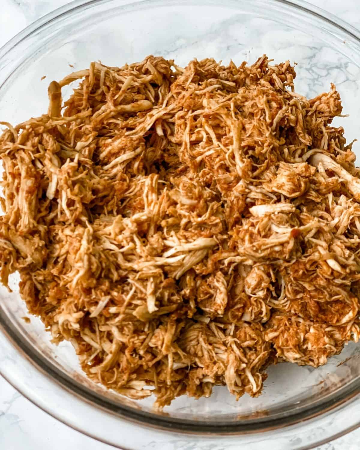 A bowl of shredded mexican chicken.
