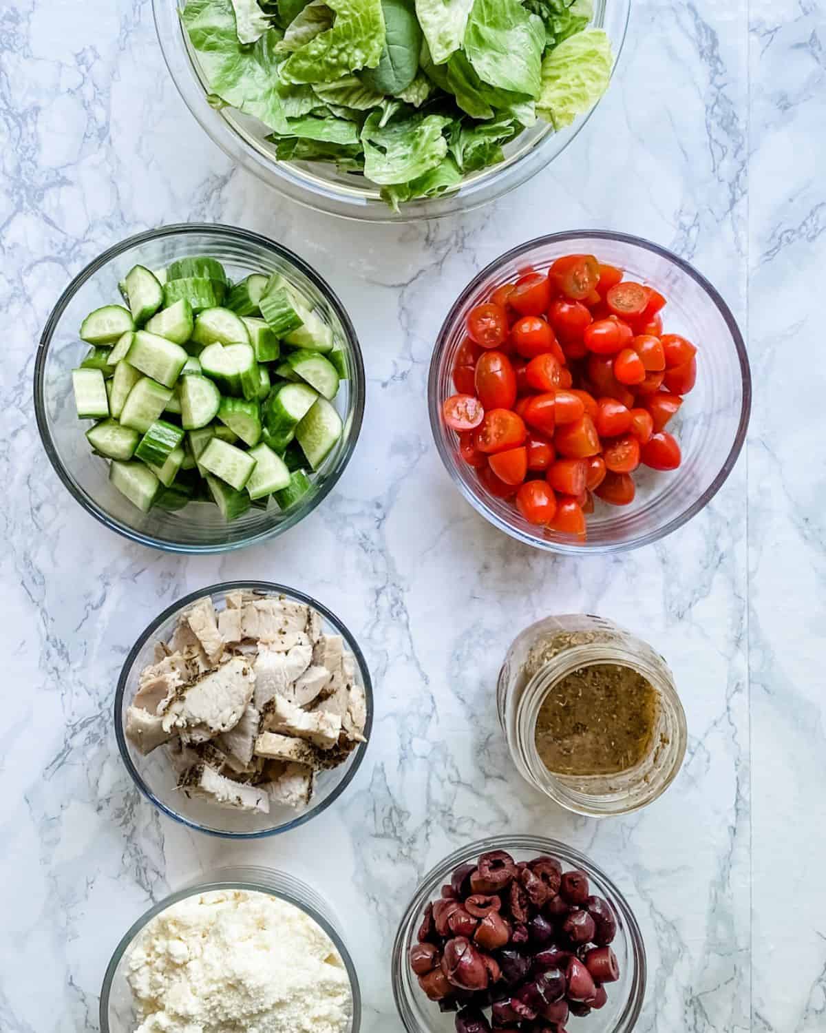 ingredients to make greek chicken salads.