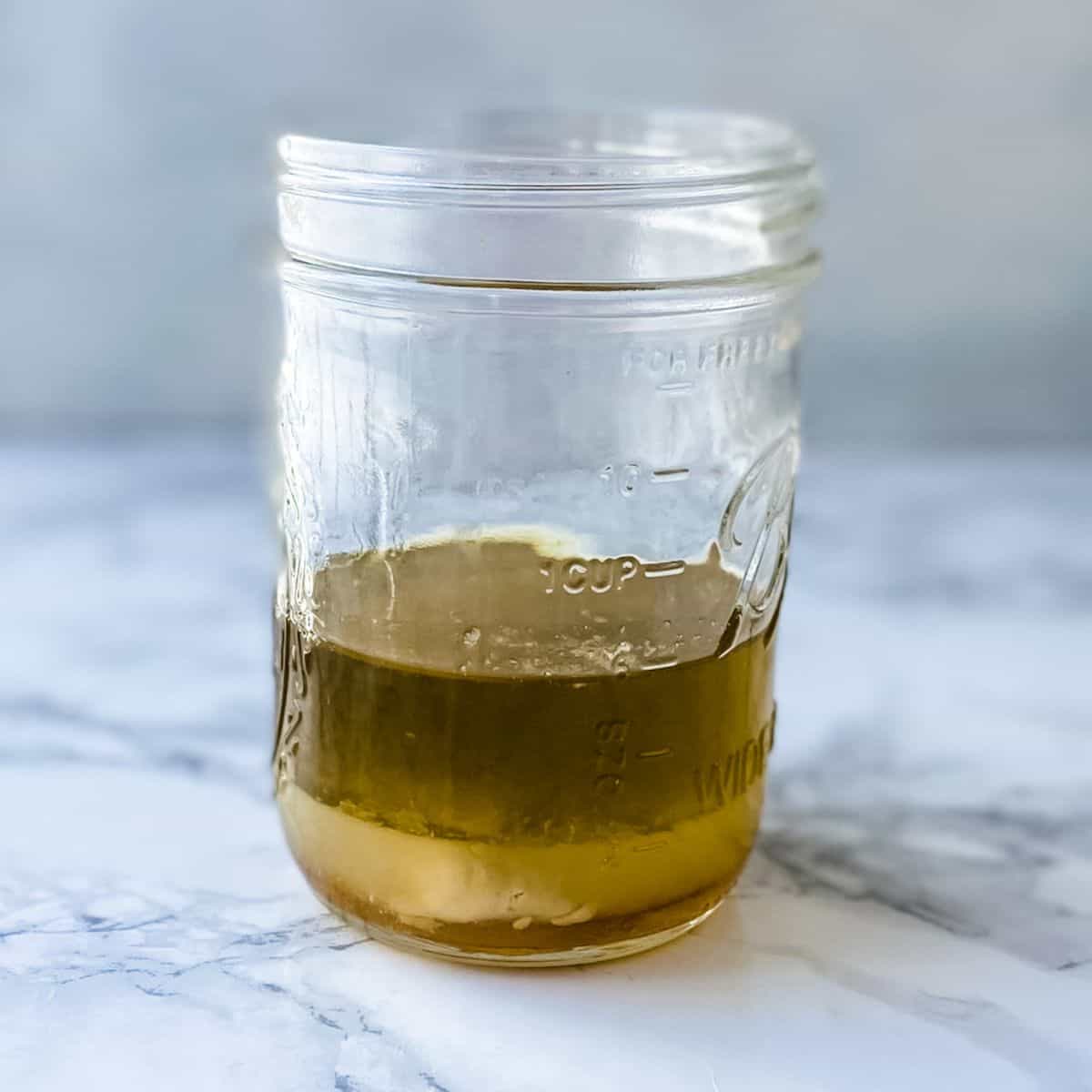 add the lemon dressing ingredients into a mason jar.