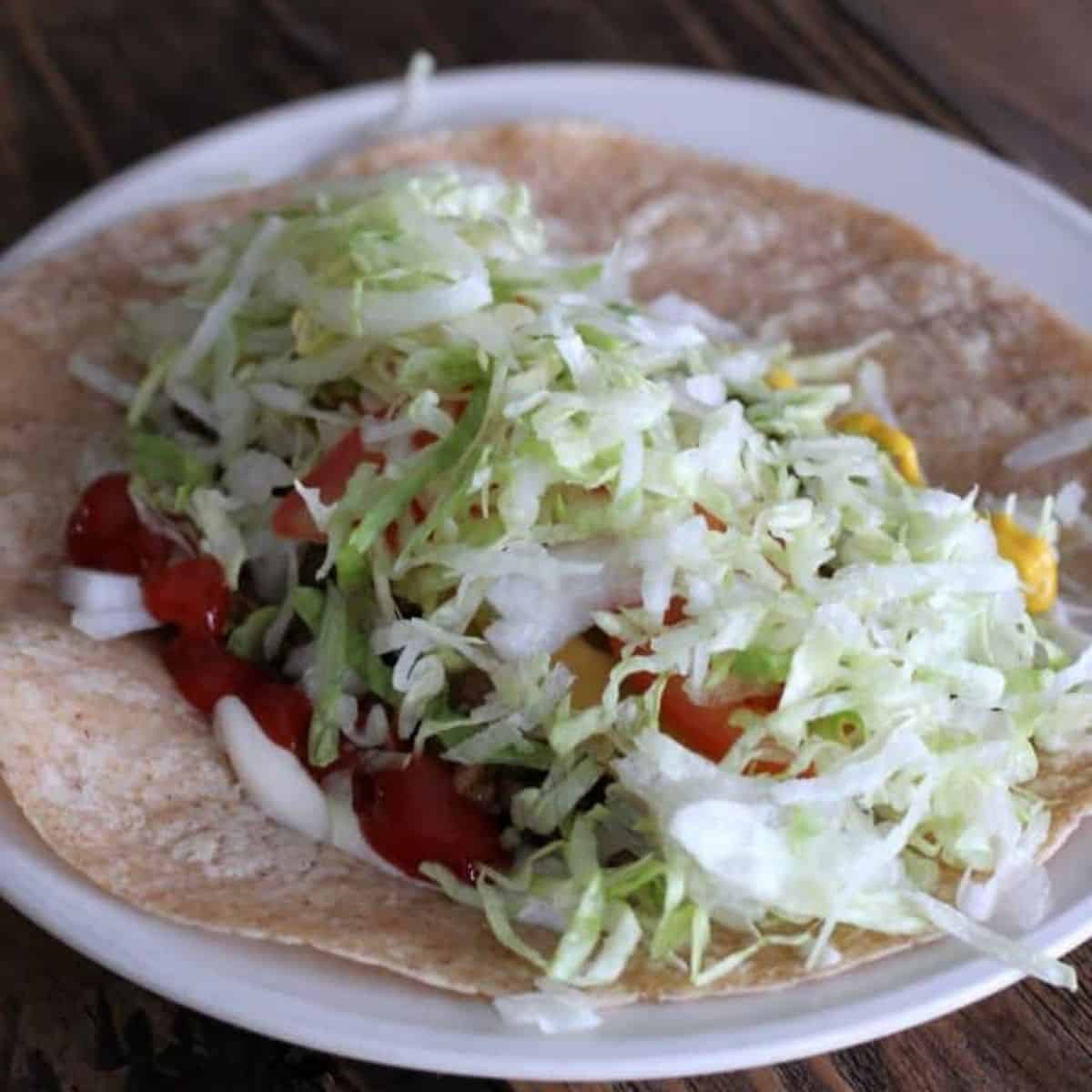 all of the ingredients for the cheeseburger wrap in the tortilla.